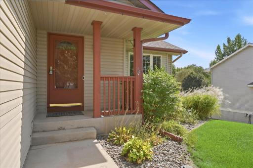 Inviting covered front entry surrounded by established landscaping creates a welcoming first impression.