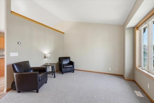 Spacious vaulted living room features new carpet, Levolor blinds, and a large front window bringing in plenty of natural light.