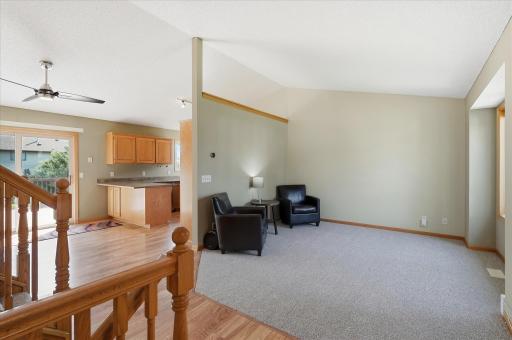 Open and inviting main level showcases the home’s four-level split design, with a vaulted living room, new carpet, and an easy flow into the kitchen and dining area.