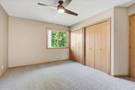 Another view of the primary bedroom highlights the generous closet space with two separate closets, providing excellent storage.