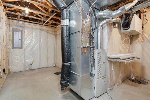 Unfinished lower-level mechanical area offers additional storage space, convenient access to the home’s mechanical systems, and a bathroom rough-in ready for future finishing.