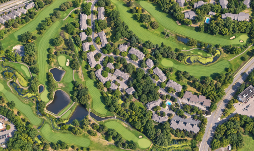 Aerial perspective of the townhome community, showing its scenic setting along Bent Creek Golf Club. Virtually enhanced.
