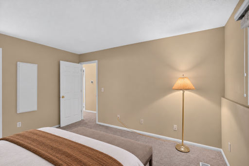 Comfortable primary suite with a private quarter bath and generous closet space. Digitally Staged