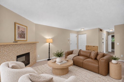 Comfortable living room with an open layout and views toward the golf course. Digitally Staged