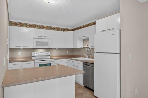 Functional kitchen with generous cabinetry and convenient access to the dining area.