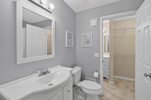 Updated walk-through full bathroom with new flooring and convenient access from the primary bedroom.