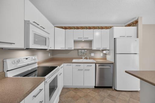 Bright kitchen with direct access to the patio and golf course views beyond.
