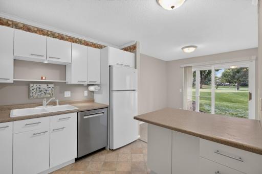 Kitchen features a breakfast bar and newer Bosch dishwasher.