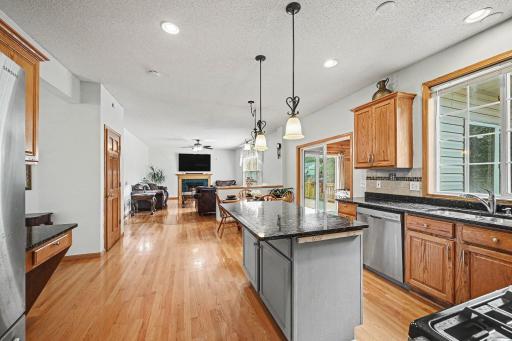 Open view from the kitchen to the family room and the deck. New hardwood floors throughout the main level.