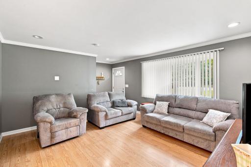 Wood and hard surface flooring throughout the main floor, crown molding, and multiple walls wired for TVs.