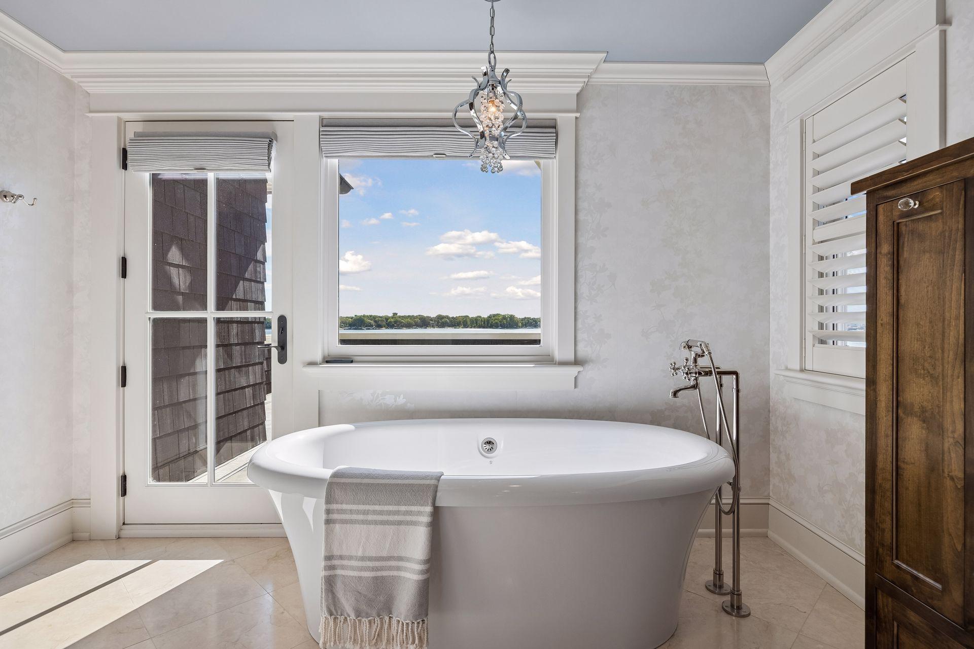 Primary bath hero with soaking tub + lake view