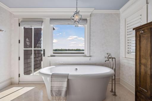 Primary bath hero with soaking tub + lake view