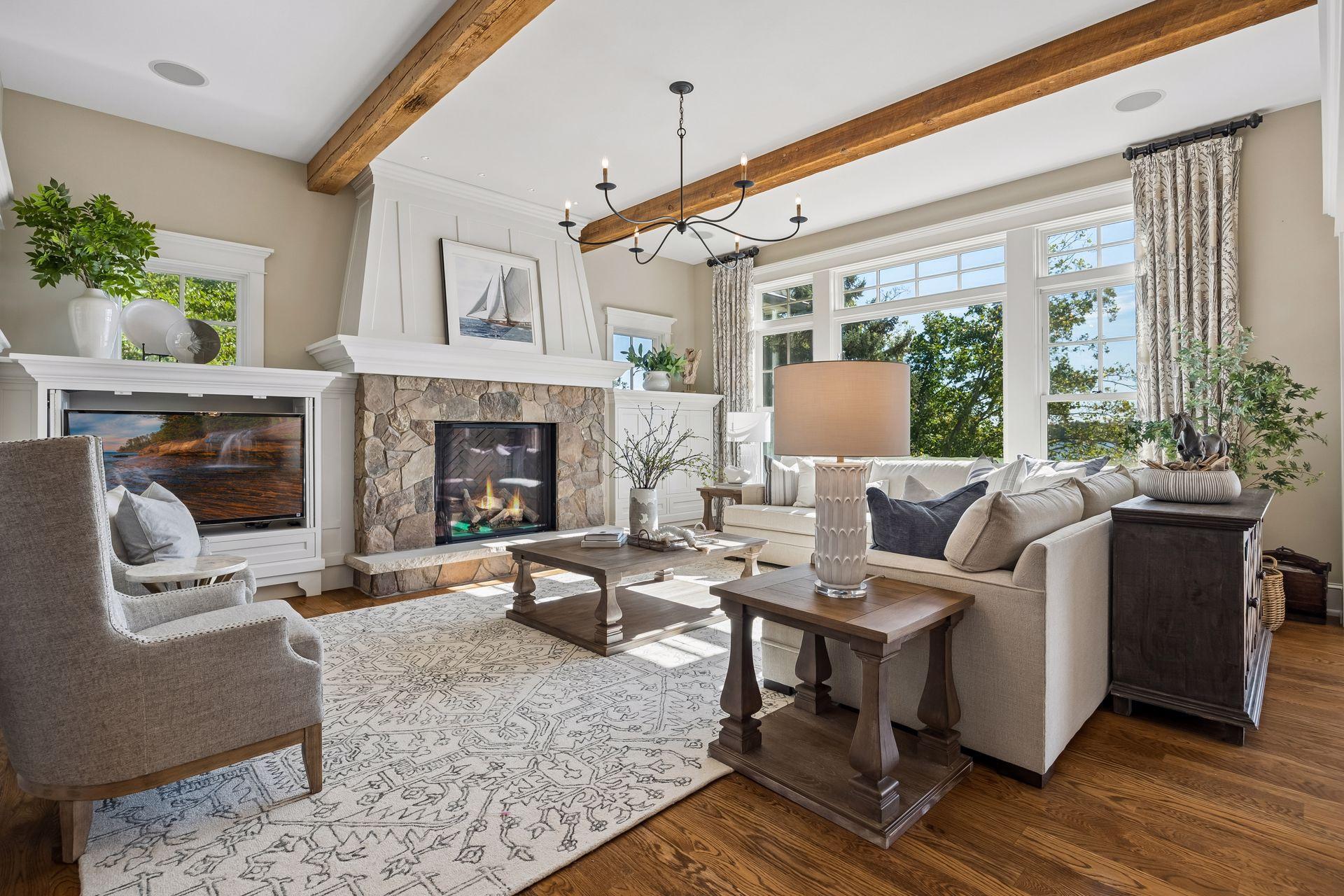 Living room with stone fireplace and exposed beams