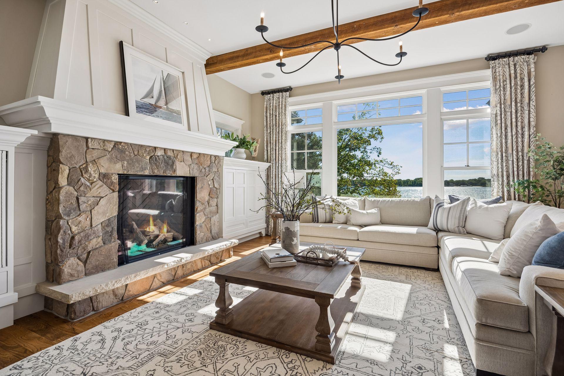 Sun-filled living room with fireplace and lake views