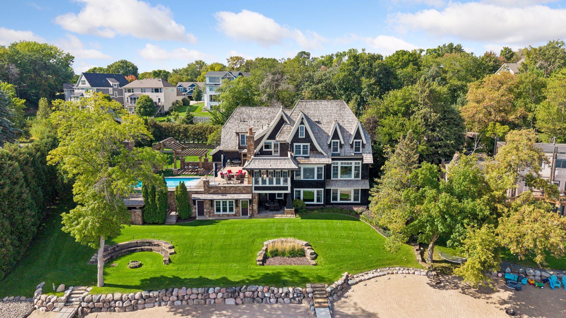 Rear exterior and expansive lakeside lawn