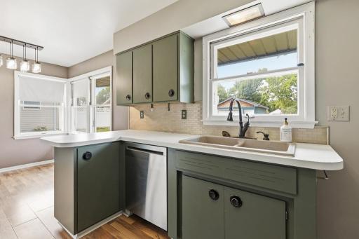 Kitchen window features a view overlooking the spacious backyard