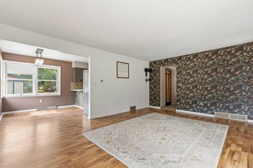 The living room opens up to the dining room and kitchen, ensuring easy conversation when entertaining!