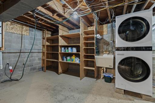 Utility and storage room also features laundry and a utility sink