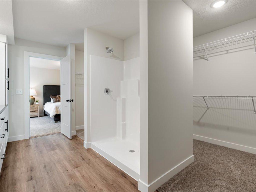 Master bathroom with stand up shower and walk in closet