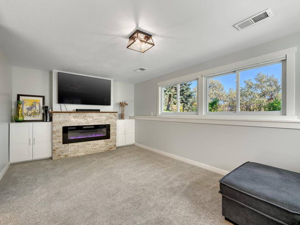 Retreat to the lower level family room and enjoy the glow from your updated electric fireplace.