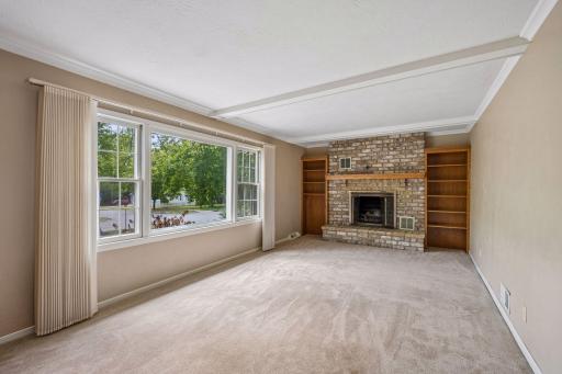 Living room includes large window and fireplace