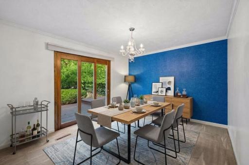 Dining room with doors out to backyard patio - virtually staged