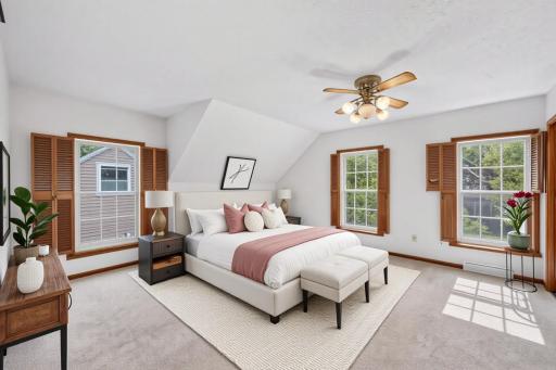 Upstairs primary bedroom is full of windows and light - virtually staged