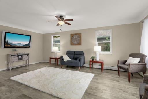 LVP flooring and coved ceilings add character to this spacious Living Room.