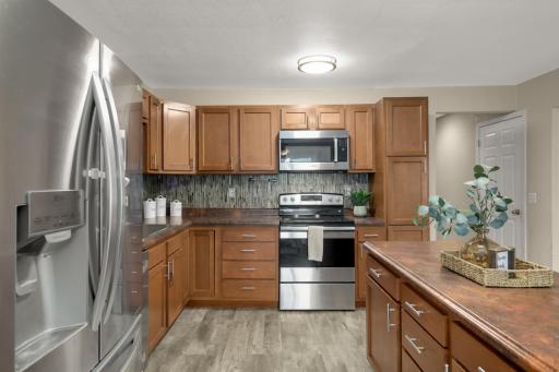 Maple cabinetry pairs nicely with the tile backsplash and neutral finishes.