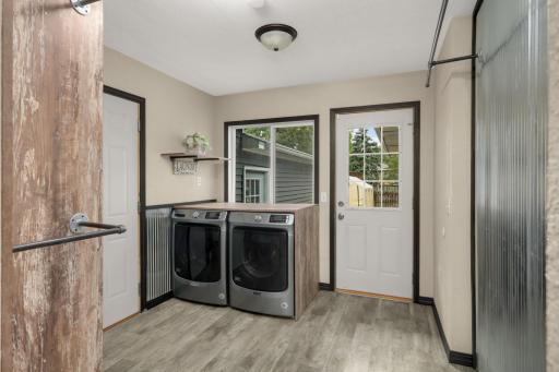Main-floor Laundry is conveniently located between the Mudroom and Garage. It also leads out to the backyard.