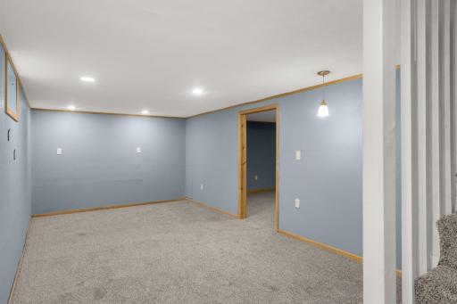 Brand-new carpet and recessed lighting freshen up the finished lower level.