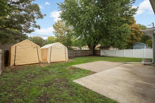 Backyard is fully fenced. Tarped sheds can stay. Large patio areas.