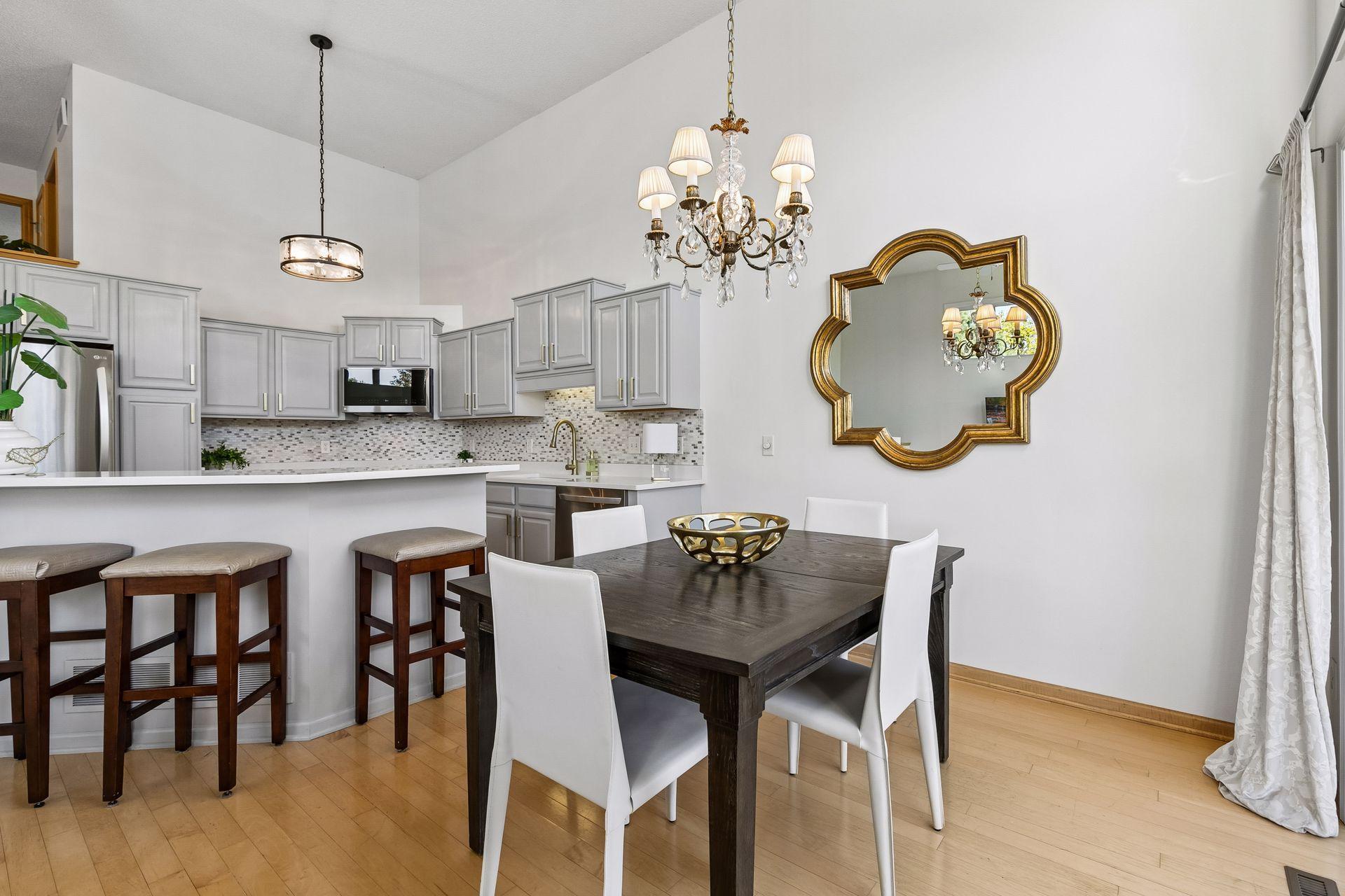 Wood flooring carries from the kitchen into the dining area, creating a natural flow between the two spaces and giving the open main level a warm, cohesive feel.