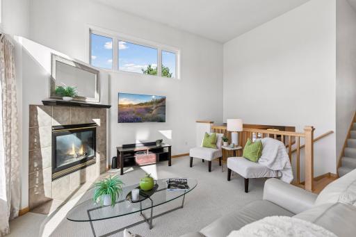 The open staircases add an architectural element to the living room.