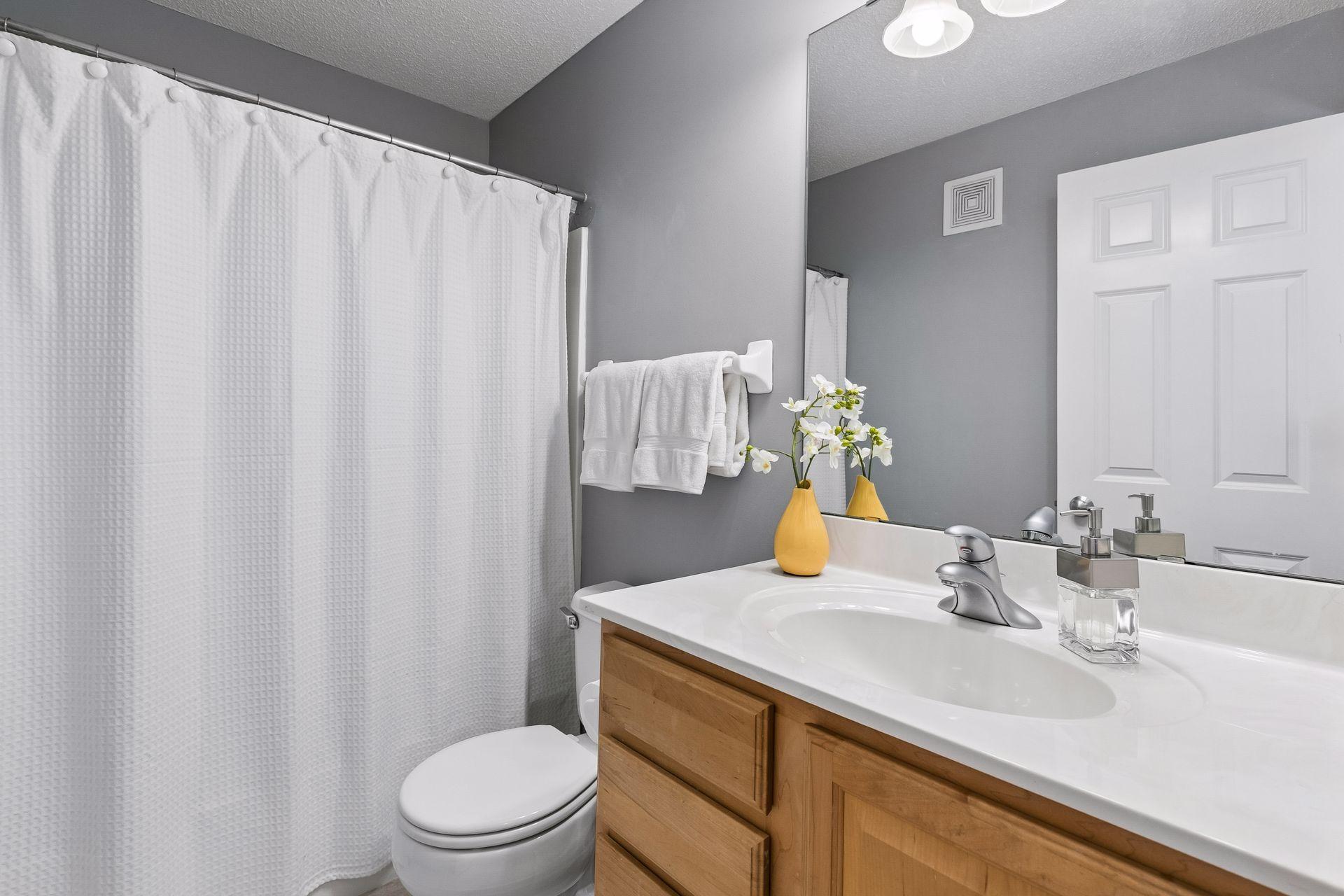 A fresh, modern finish gives the upper-level full bath a clean, contemporary feel.