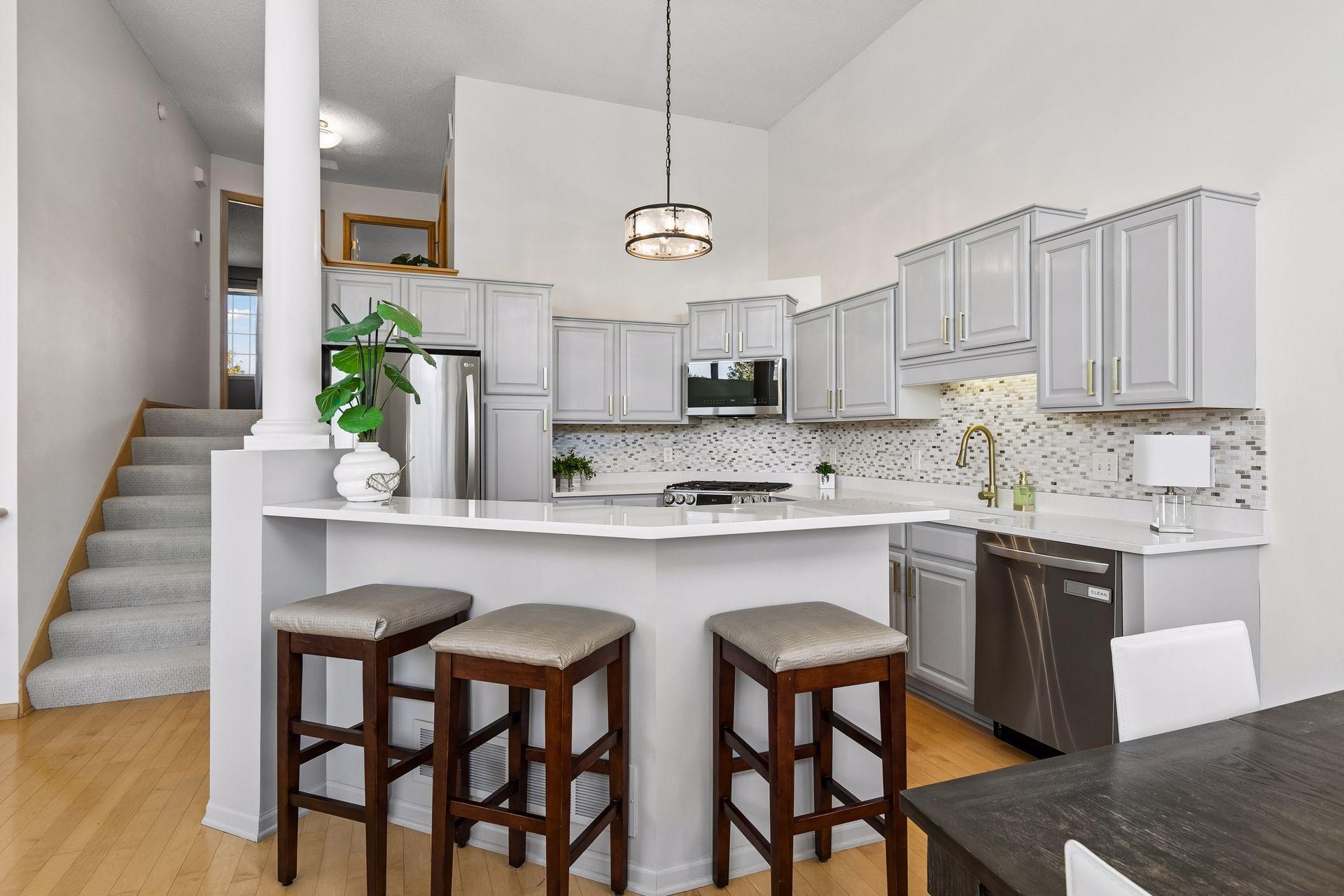 The island’s breakfast bar creates an easy spot for a quick meal, homework or conversation while keeping the kitchen connected to the rest of the main level.