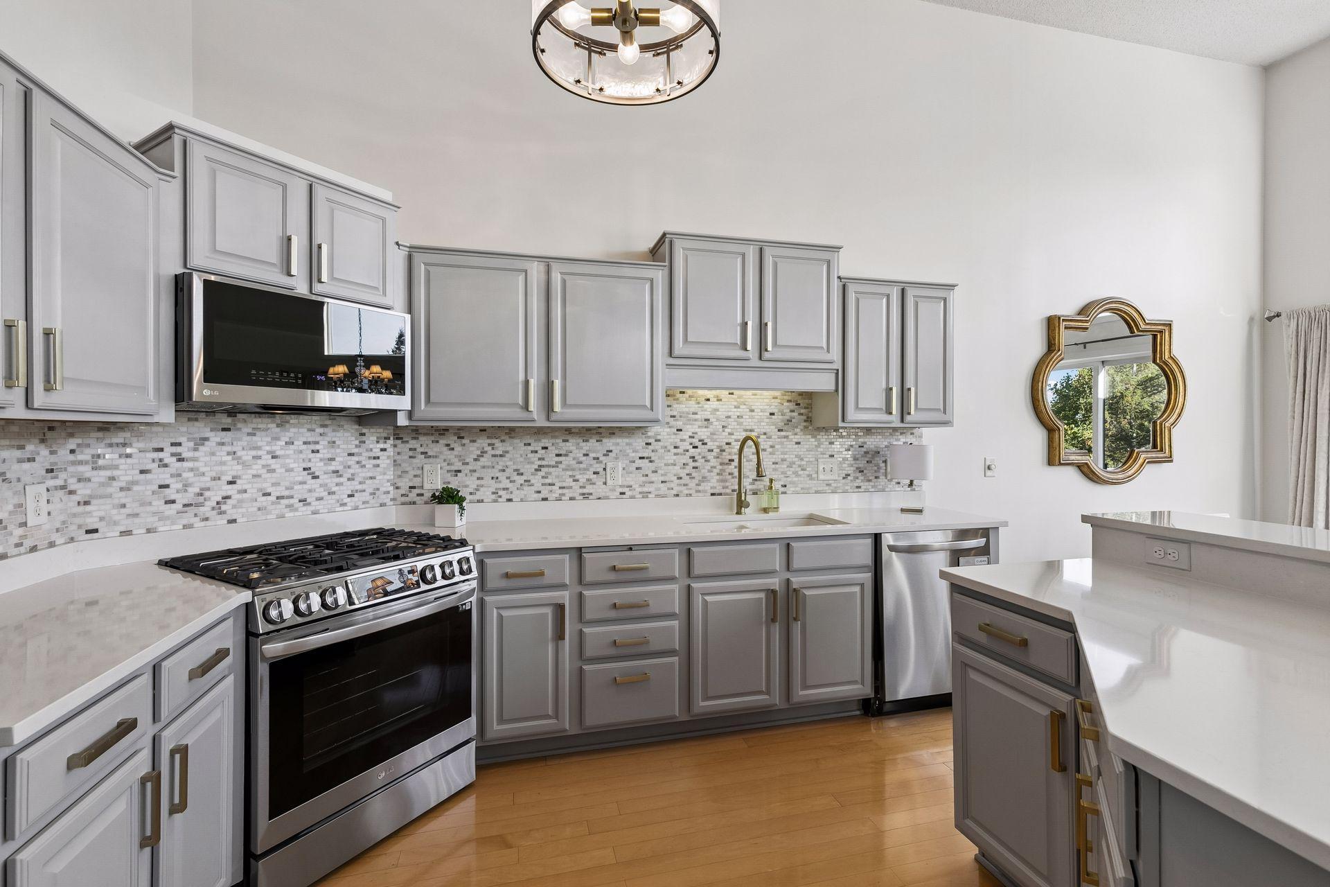 The updated kitchen pairs crisp modern finishes with stainless appliances and ample counter space that makes this space as practical as it is polished.