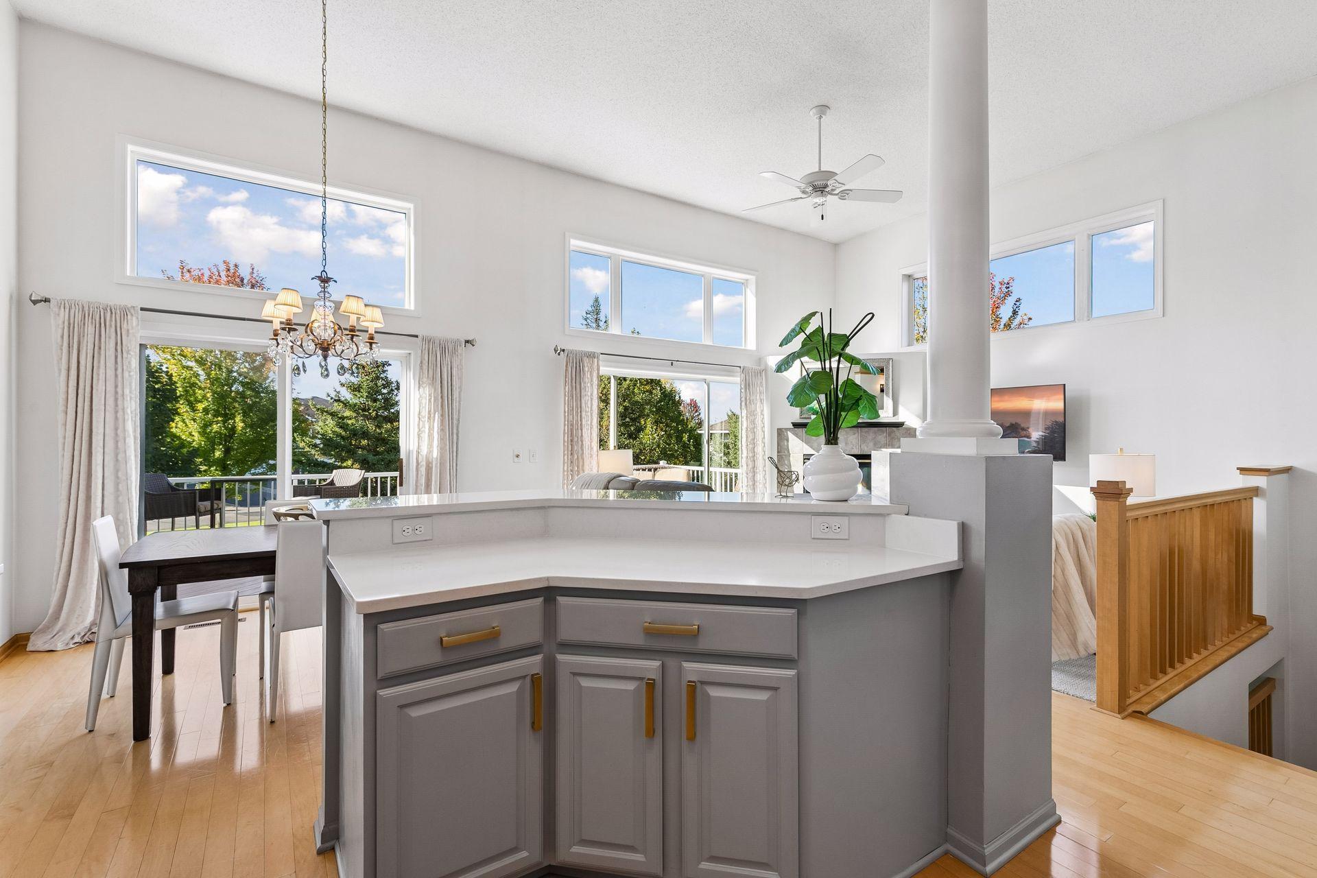 The kitchen opens directly to the vaulted living area, so natural light and the sense of space continue from one end of the main level to the other.