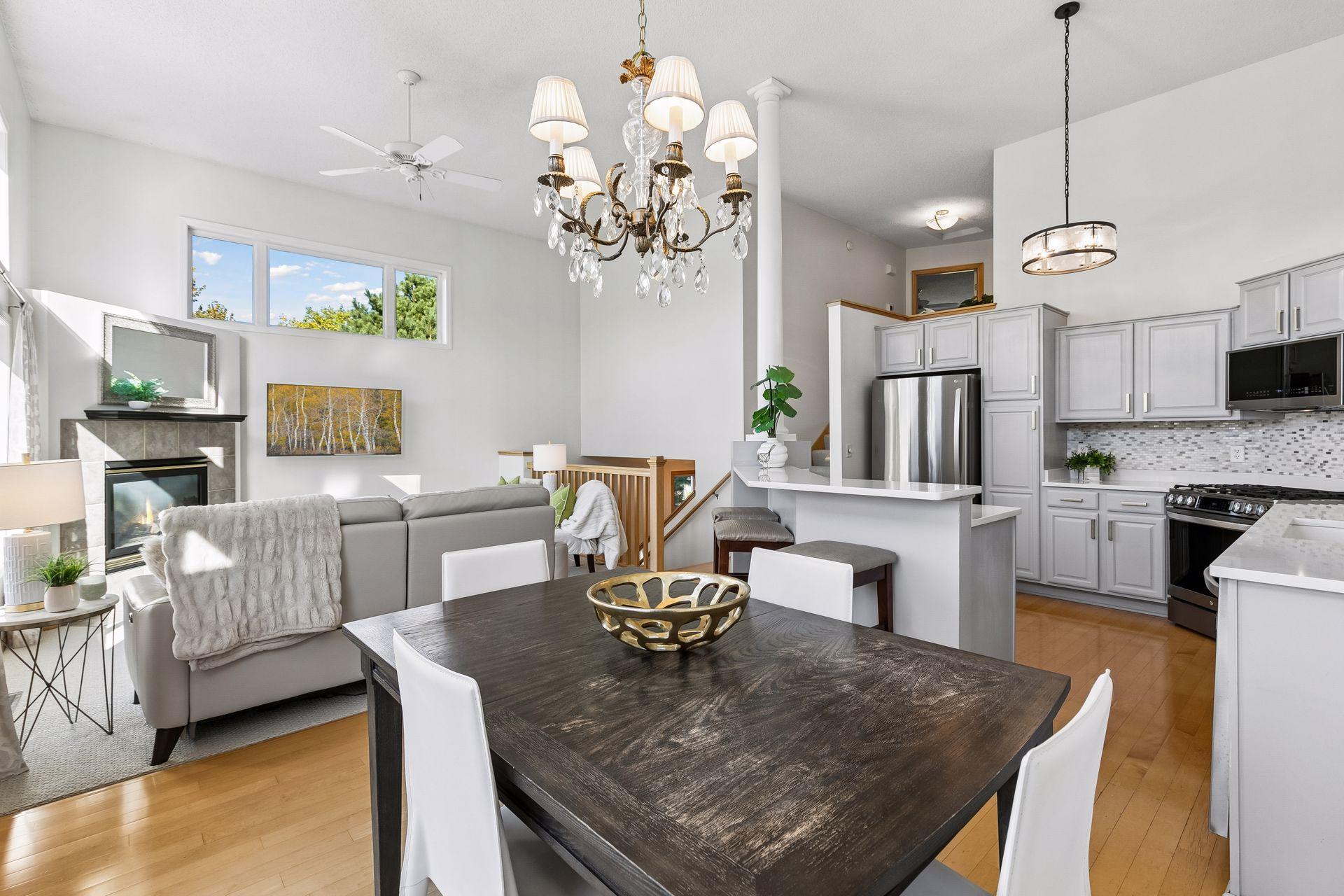 The dining room connects the kitchen and living areas while maintaining its own defined space, with wood floors and abundant natural light adding to its appeal.