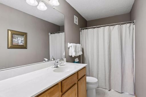 Modern finishes give the primary en-suite bath a fresh, polished look.