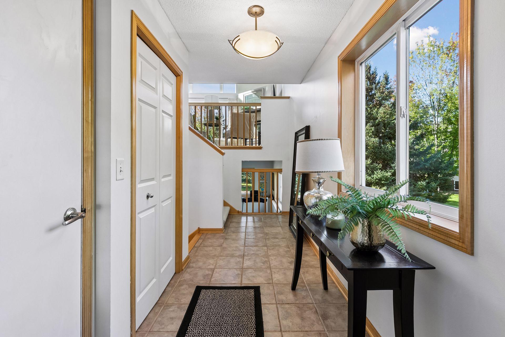 The entry foyer makes coming and going easy with direct access to the garage, while natural light from the foyer window brightens the entry and open sight-lines reveal both the main living level above and the finished lower level.