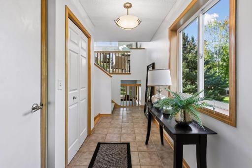 The entry foyer makes coming and going easy with direct access to the garage, while natural light from the foyer window brightens the entry and open sight-lines reveal both the main living level above and the finished lower level.