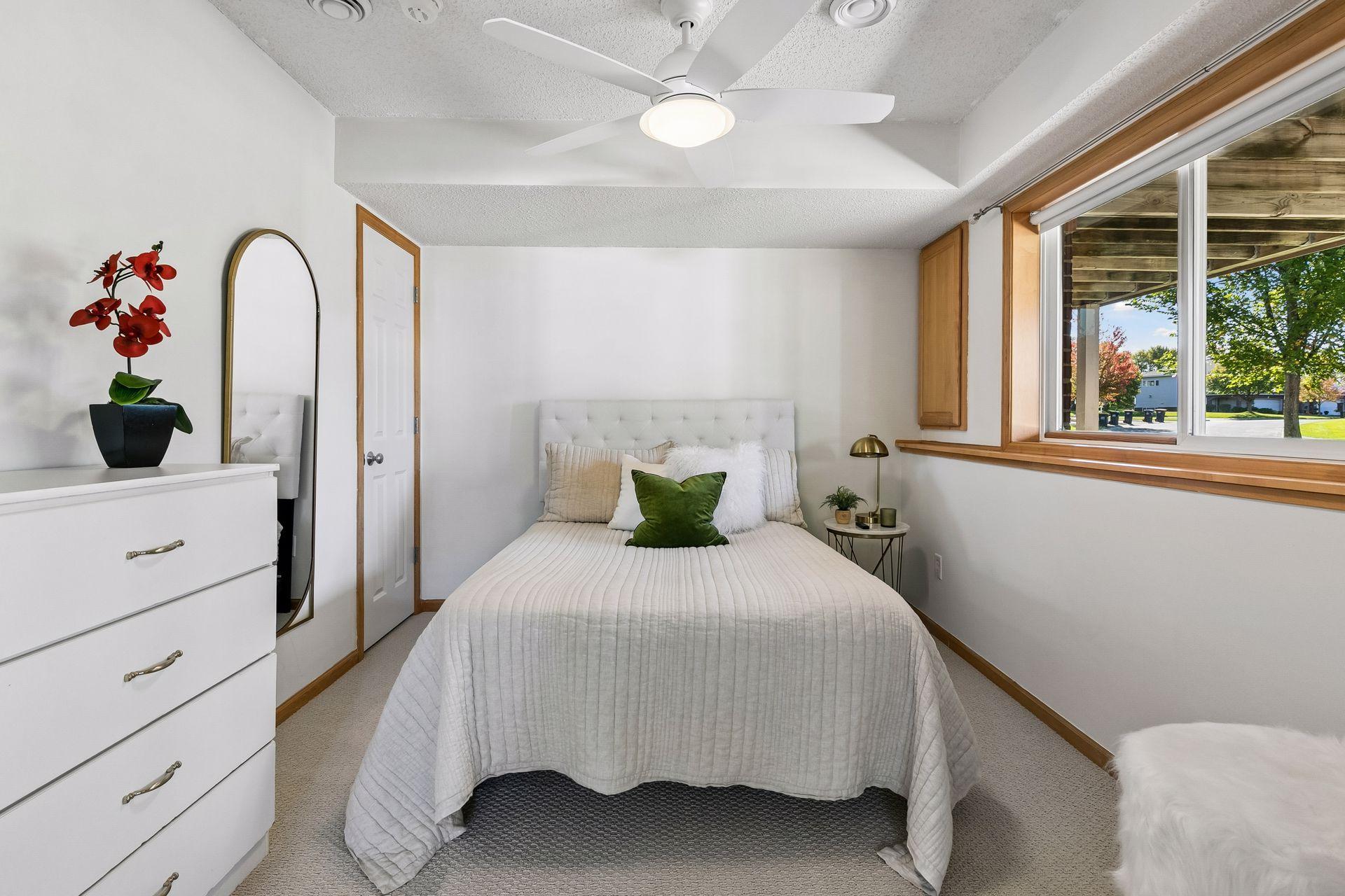 Large windows make the lower-level bedroom feel bright and welcoming.