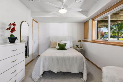 Large windows make the lower-level bedroom feel bright and welcoming.