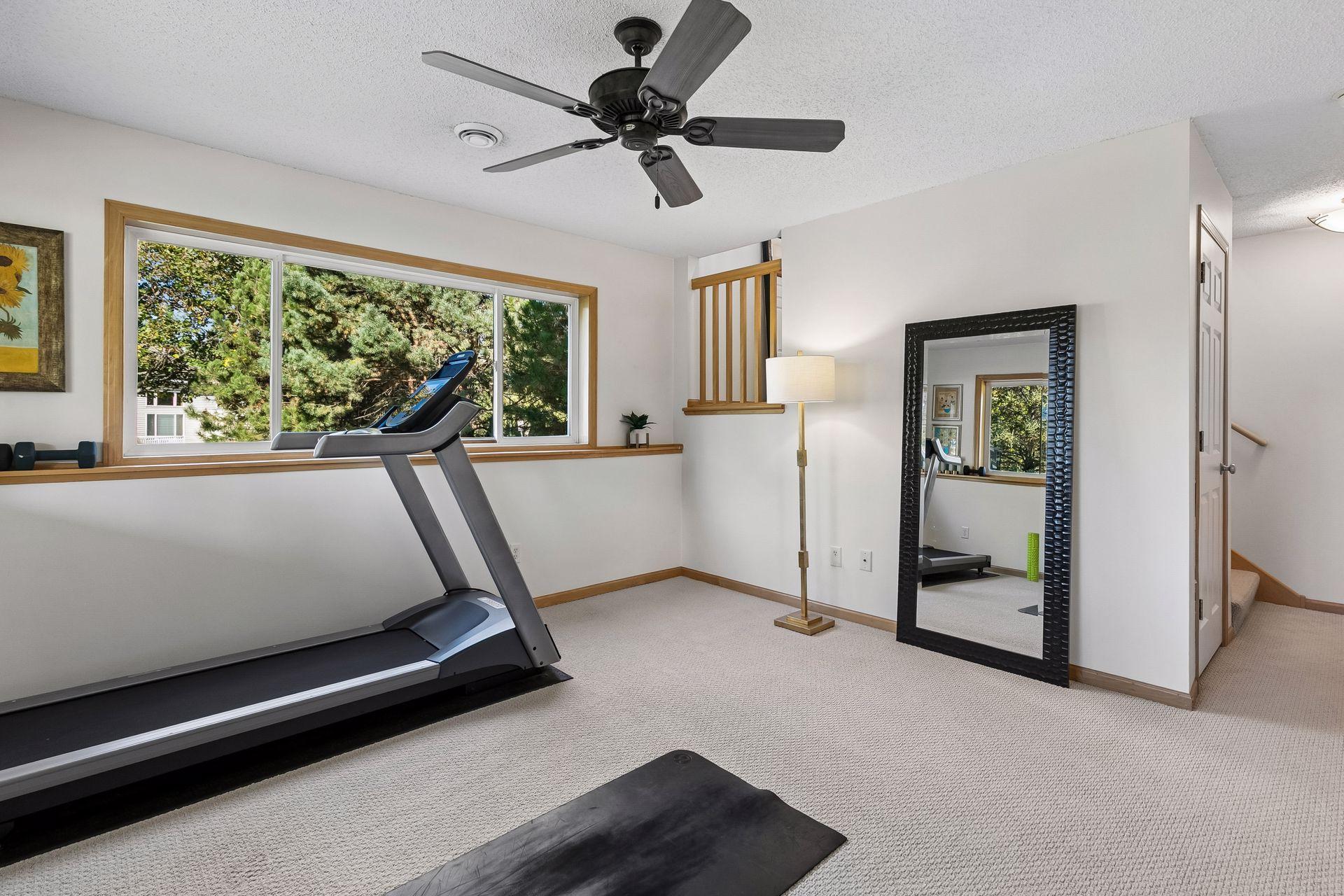 Open sightlines connect the lower family room to the entry foyer, while a separate staircase leads to an additional bonus storage room on its own level.