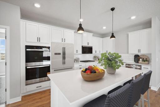 Large center island with spacious seating along with corner pantry highlight are just some of the highlights in the kitchen. *Picture is of model home. Actual finishes may vary.