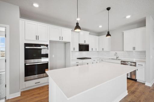Large center island with spacious seating along with corner pantry highlight are just some of the highlights in the kitchen. *Picture is of model home. Actual finishes may vary.