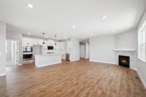 Open main level with laminate flooring throughout provides a great space for any type of gatherings. *Picture is of actual home.
