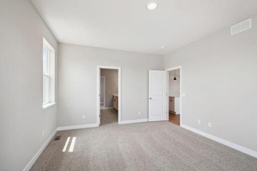 Primary bedroom suite with ensuite bathroom and DUAL walk-in closets provide a pleasant escape the rest of the home. *Picture is of model home. Actual finishes may vary.