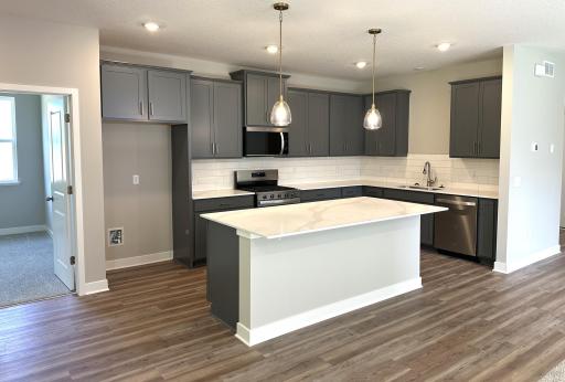 With accent gold pendants and pulls, this kitchen is a true showstopper. Picture is of actual home!